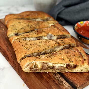 Stuffed Focaccia: Simple, Italian inspired meal  has all the flavors of your favorite pizza. Golden, warm, yeasty  bread stuffed with plant based savory  sausage and cheese, served with a side of a robust sweet marinara sauce makes easy, fun party dinner.