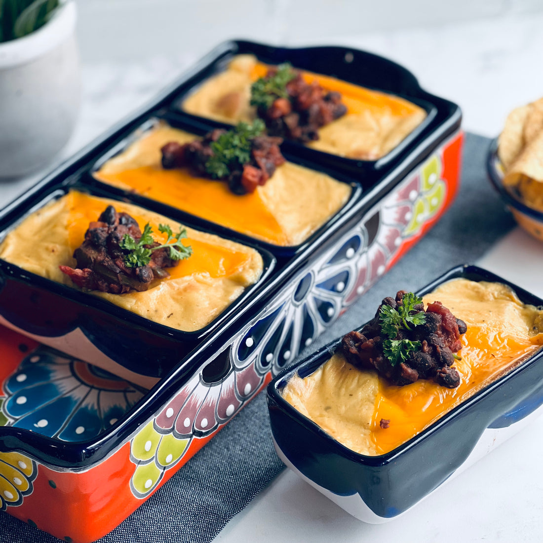 Black Bean Enchiladas: Smoky black beans, peppers, and tomatoes tossed with Mexican spices, rolled in corn tortilla, topped with cheesy, creamy sauce, then baked golden. 